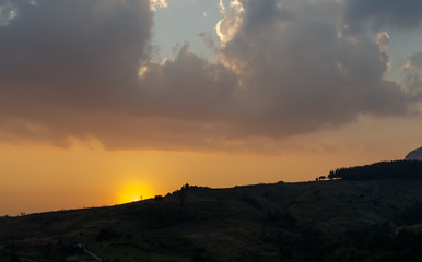 silhouette mountain when sun rising over mountain