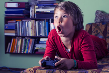 Boy teenager playing a video game console.