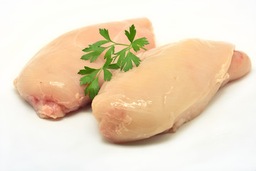 Two chicken breast isolated in white with parsley