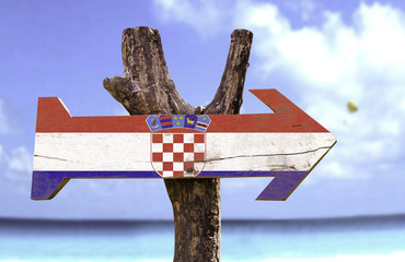 Croatia wooden sign with a beach on background