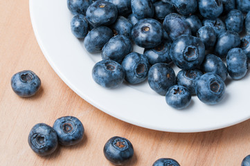 Fresh blueberries on the wooden table.
