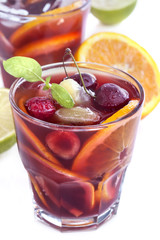 Ice refreshing summer drink with lots of different fruits