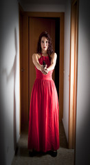 Fototapeta premium Beautiful Woman with a red dress and a gun
