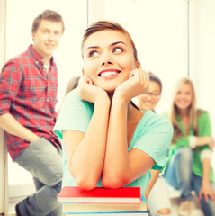 happy smiling student girl with books at school