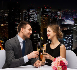 couple with glasses of champagne at restaurant