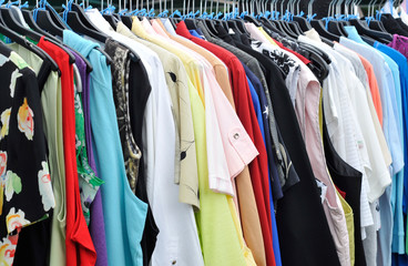 clothes on a rack in a flea market - 68134861