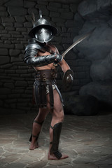 Gladiator in helmet and armour holding sword