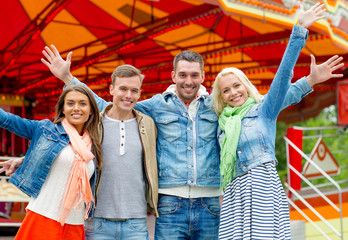 group of smiling friends waving hands