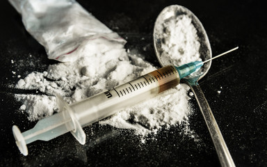 Drug syringe and cooked heroin - obrazy, fototapety, plakaty