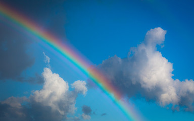 Skyscape view on blue sky with rainbow