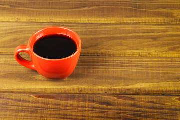 Cup of coffee on a wooden table.
