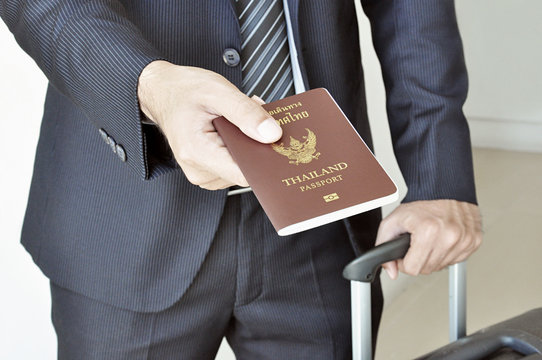 Businessman hand showing passport - airport security concept