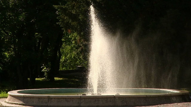 fountain with water splashes in  sunlight