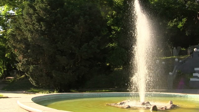 fountain with water splashes in  sunlight. Panorama