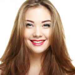 Naklejka premium Beauty woman face. Young girl smiling. Isolated on white backgro