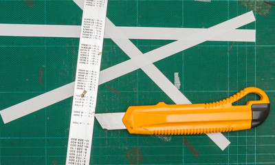 Green cutting mats with iron ruler and yellow cutter.