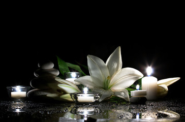 Fototapeta na wymiar white lily, stones and candles