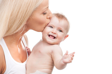 happy mother kissing smiling infant.