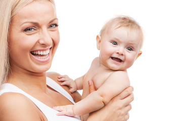happy mother holding infant and smiling.