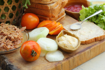 making tuna sandwich with fresh vegetables