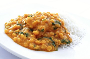 Indian tarka dhal lentil curry on plate with rice