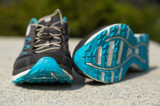 Close up of modern trail running shoes in a park.