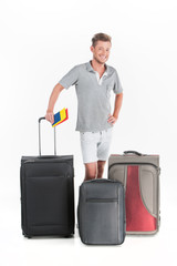 handsome guy standing with luggage and smiling.
