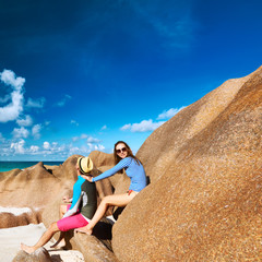 Couple at tropical beach wearing rash guard