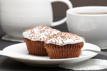Cupcakes With Cocoa White Cream And Sprinkles. Coffee And Milk
