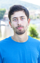 Portrait of a friendly guy with beard outside