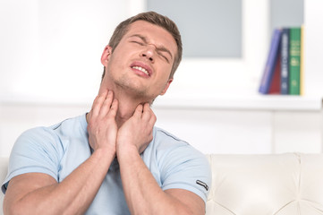 Portrait of handsome male with pain in throat.