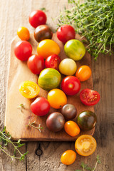 Fototapeta na wymiar colorful tomatoes over wooden background