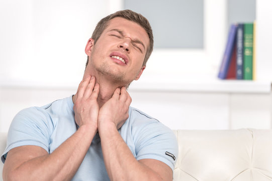 Portrait Of Handsome Male With Pain In Throat.