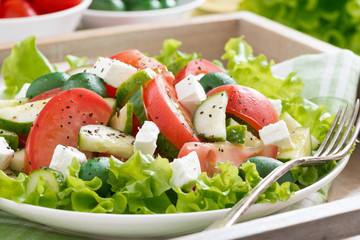 plate of green salad with vegetables, close-up