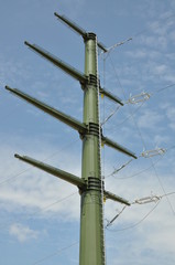 High voltage electric tower against blue sky