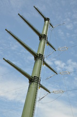 High voltage electric tower against blue sky