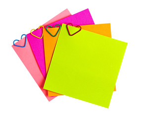 memo paper and clip in the form of heart isolated on white