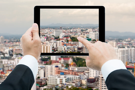 Businessman hands tablet taking pictures view edifice of city