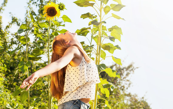 Teenage Girl In Sunflower Field, With Open Arms