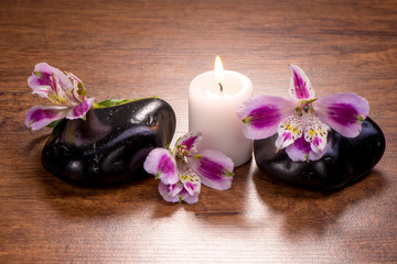 Beautiful spa setting with orchid and candle on wooden table
