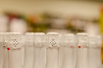 close up of champagne bottleneck with white paper