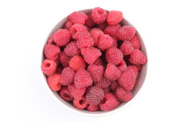 Fresh raspberries with a bowl on a white background