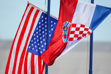 Croatian and American flags waving