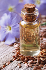 flax oil in a bottle macro on a background of flowers and seeds
