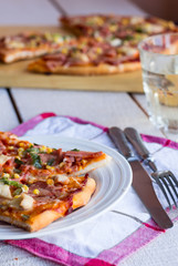 pizza with sausage, chicken, corn and cheese