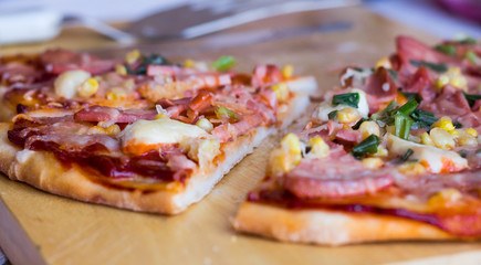 pizza with sausage, chicken, corn and cheese