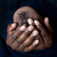 Black father holding newborn baby