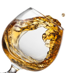 Splash of cognac in glass isolated