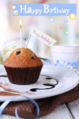 Blueberry muffin on bright background