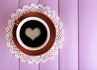 Cup of strong coffee on color wooden background